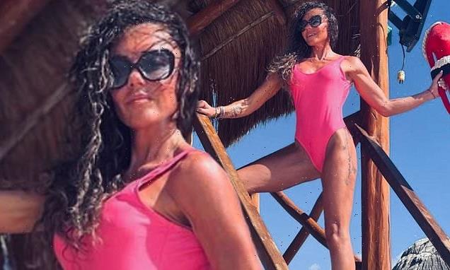 Michelle Heaton channels Pamela Anderson in a neon pink swimsuit