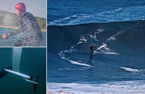 Surfer tackles a 50ft wave in Portugal on board a FLYING surfboard