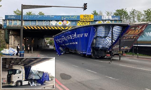 Toilet roll lorry crashes into low railway bridge in London