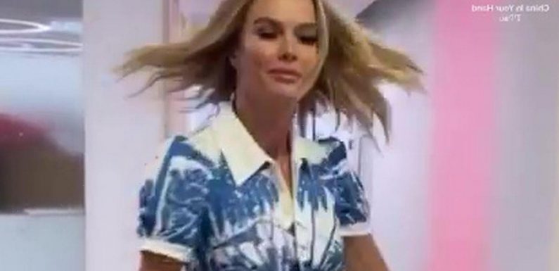 BGT’s Amanda Holden shows off toned legs as she twirls skirt in glam work video