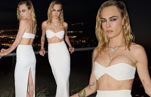 Cara Delevingne puts on a busty display and flashes her toned abs