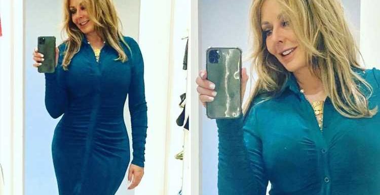Carol Vorderman thrills fans as she shows off her curves in a skintight blue dress with huge thigh slit