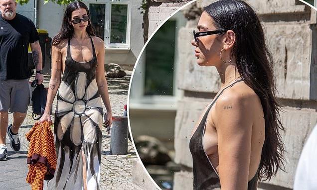 Dua Lipa displays her cleavage in a very low cut maxi-dress in Berlin