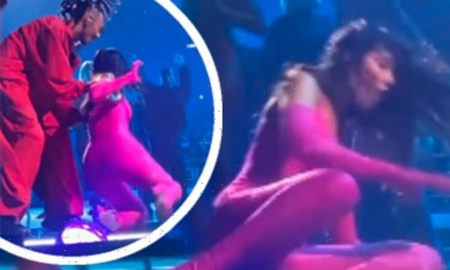 Dua Lipa slips and FALLS OVER while performing on stage in Milan