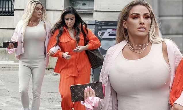 Katie Price parades her famous curves in a skintight cream catsuit