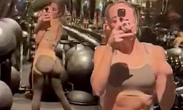 Khloe Kardashian shows off her very toned tummy in a sports bra
