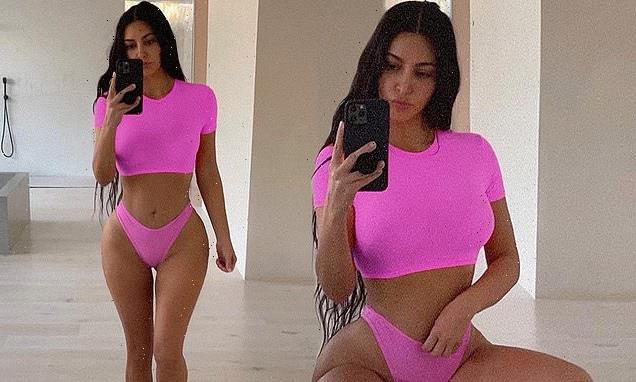 Kim Kardashian poses in racy neon