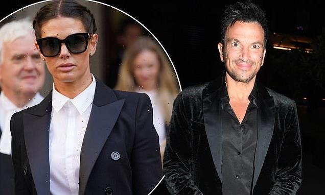 Peter Andre flashes a smile as he leaves the theatre amid manhood saga