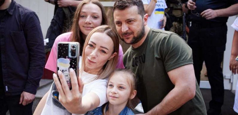 Defiant Volodymyr Zelensky poses for selfie on bombarded Ukraine frontline