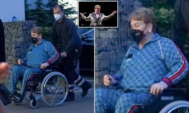 Frail-looking Elton John, 75, is pushed in a wheelchair