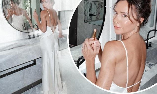 Victoria Beckham looks incredible in a backless silk white dress