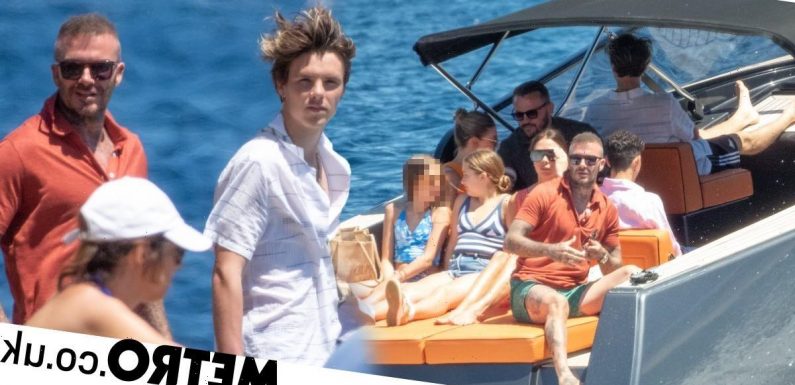 David Beckham shows off new hairdo as he soaks up sun on boat with family