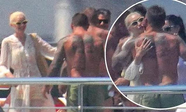 Gigi Hadid shares a warm hug with a shirtless David Beckham