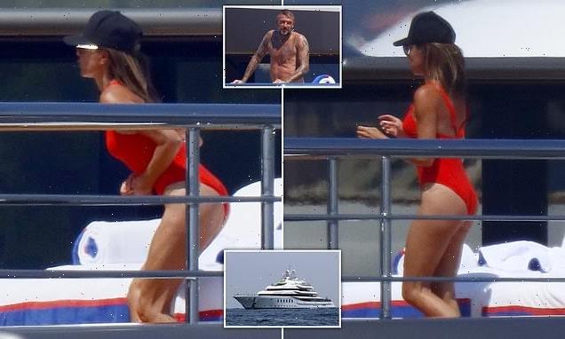 Victoria Beckham shows off her athletic physique in a red swimsuit