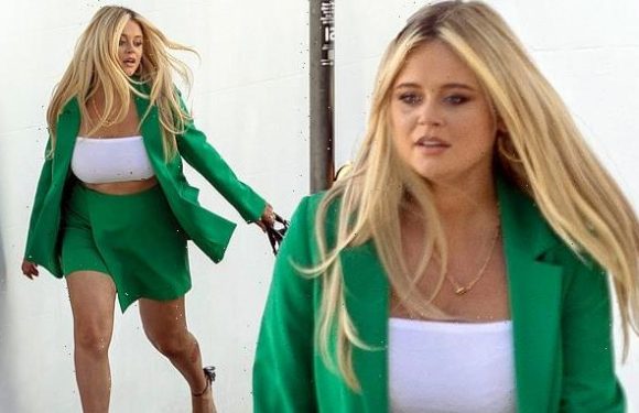 Emily Atack displays her toned legs in green shorts