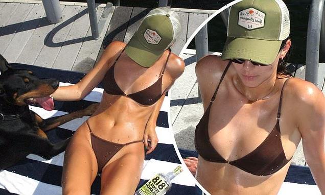 Kendall Jenner flaunts her tanned physique in a daring brown bikini