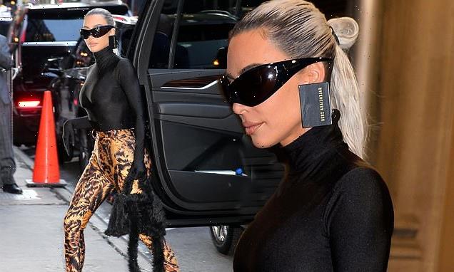 Kim Kardashian shows off her slender frame in polo neck