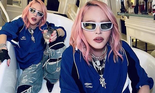 Madonna, 64, poses for edgy snaps in a bathtub debuting new pink hair