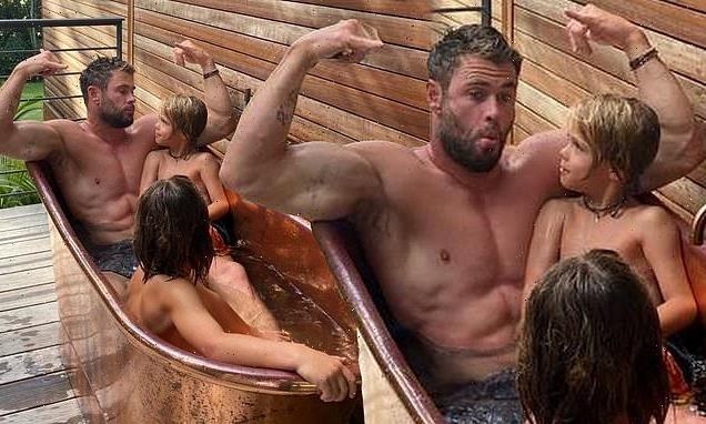 Chris Hemsworth shows off his huge biceps as he takes a bath with sons