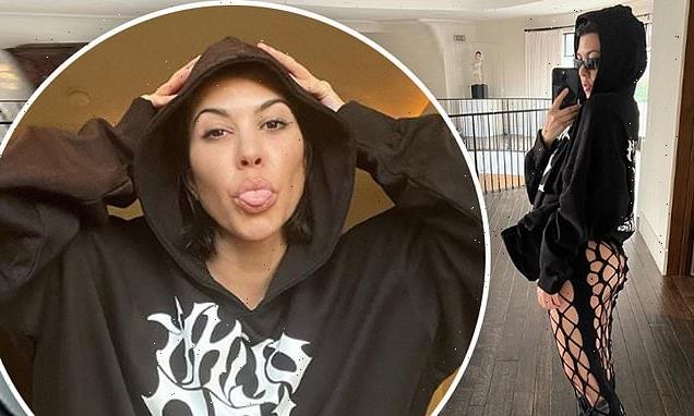 Kourtney Kardashian flashes her derriere in fishnet skirt