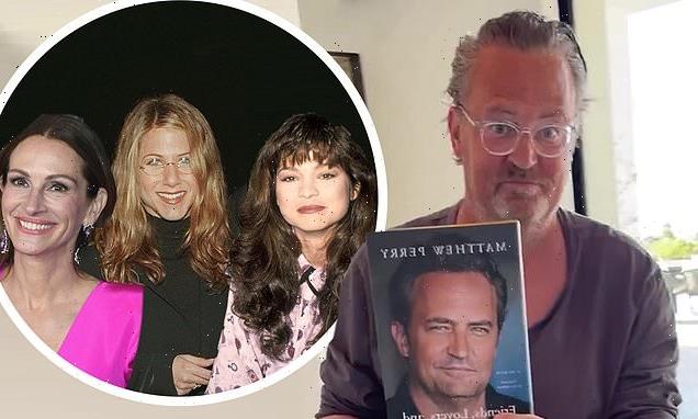 Matthew Perry looks proud as he holds up book after dishing on Aniston