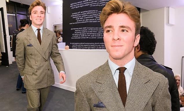 Rocco Ritchie cuts a dapper figure in a tweed suit at exhibition