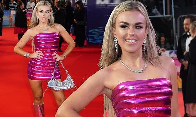 Tallia Storm wows in a pink mini dress and knee high boots in London