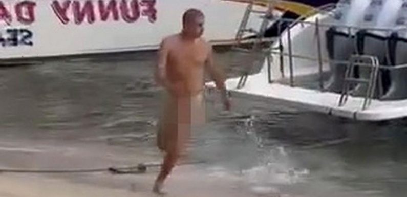 Drunk Russian bloke walks around tourist beach in the nude with erection