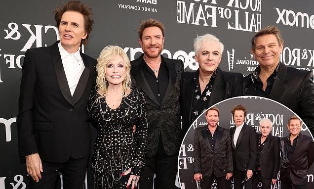 Duran Duran and Dolly Parton pose at Rock and Roll Hall of Fame