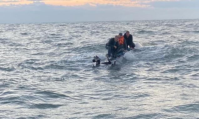 Men forced to sit on hull of capsized boat, waiting to be rescued