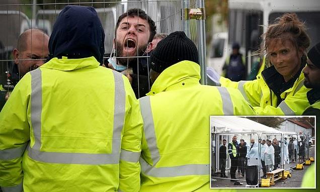 Migrant outside Manston immigration centre is pinned against fence