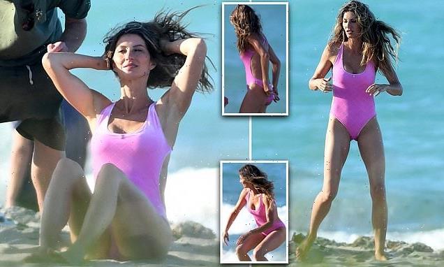 Gisele Bundchen showcases her supermodel frame in pink swimsuit
