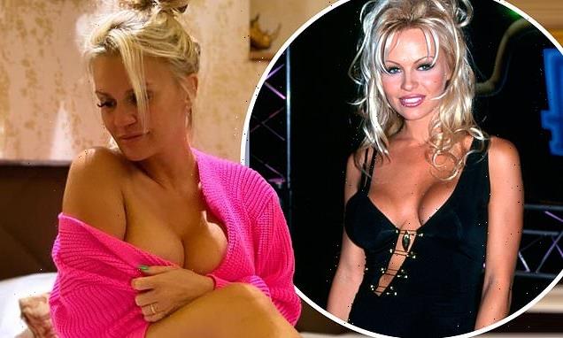 Kerry Katona exposes her ample cleavage in a pink cardigan