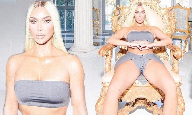 Kim Kardashian shows off her abs in a pale gray bikini