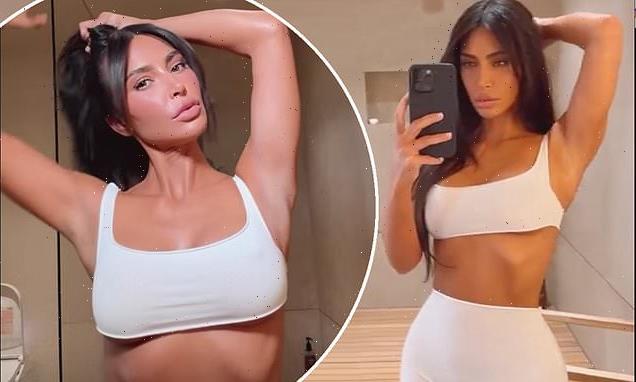 Kim Kardashian shows off her ultra-toned figure in a white co-ord