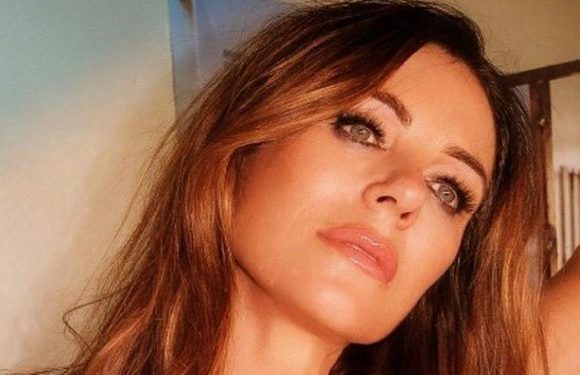 Liz Hurley leaves little to imagination as she almost spills out of low-cut robe