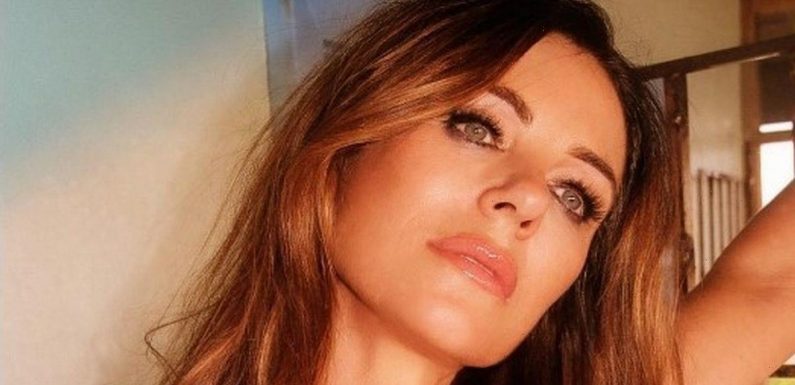 Liz Hurley leaves little to imagination as she almost spills out of low-cut robe