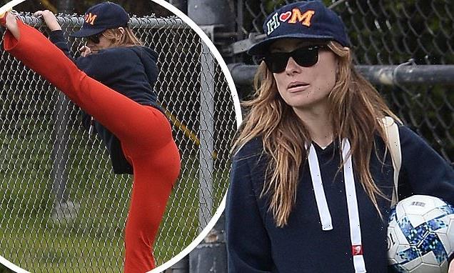 Olivia Wilde shows off her VERY flexible side as she does stretches