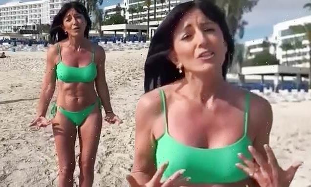 Davina McCall, 55, showcases her washboard abs in a green bikini