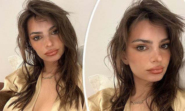 Emily Ratajkowski puts on a busty display in unbuttoned gold top