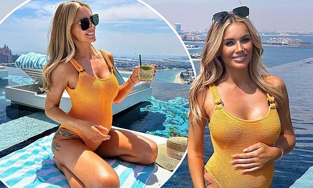 Pregnant Laura Anderson showcases her baby bump in orange swimsuit