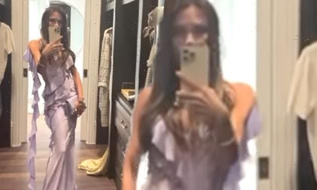 Victoria Beckham shows off her slim figure in a flowing lilac dress