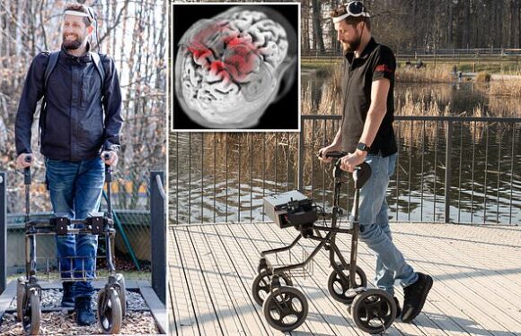 Paralysed man walks for the first time in 12 YEARS thanks to implant