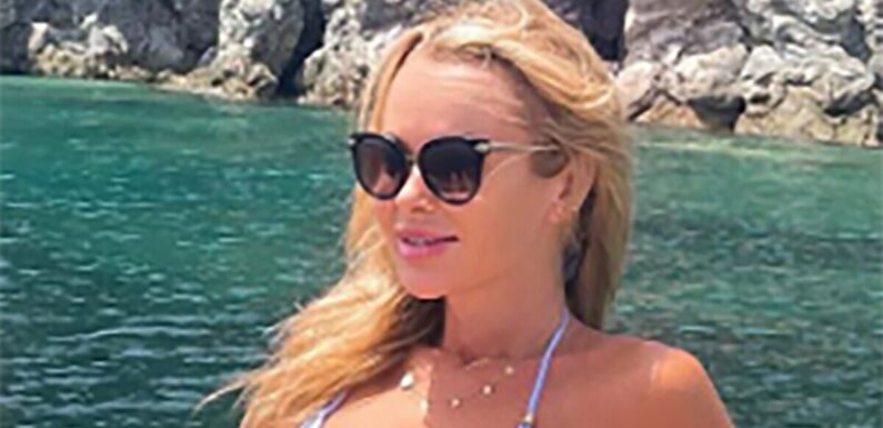 Amanda Holden gives ‘Bond girl vibes’ as she sunbathes in tiny blue bikini