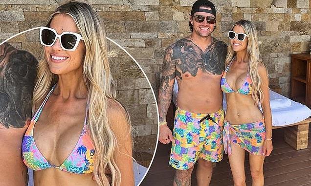 Christina Hall, 40, and husband Joshua Hall, 42, in matching swimwear