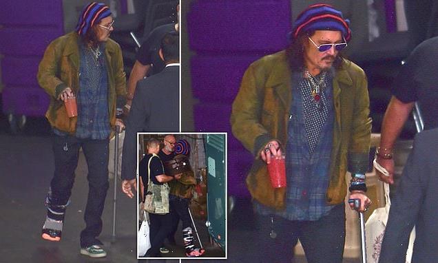 Johnny Depp walks with a medical boot and a crutch amid ankle injury