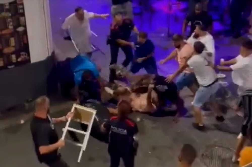 Shocking video shows massive brawl on Spain’s ‘Sin Street’ as drinkers batter each other with chairs & smash bottles | The Sun