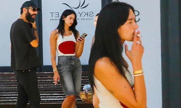 Dua Lipa puffs on a cigarette while in Ibiza with beau Romain Gavras