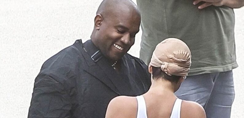 Kanye West smiles with Bianca Censori as she models revealing look