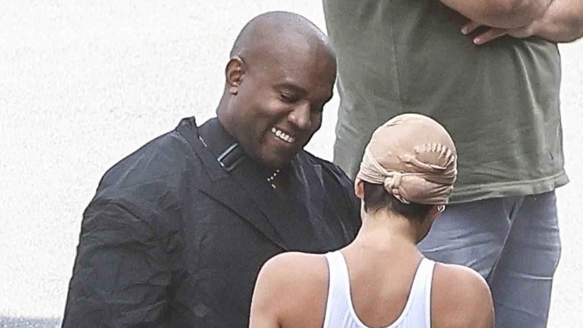 Kanye West smiles with Bianca Censori as she models revealing look